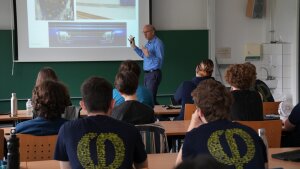 A lecturer gives a lecture to students