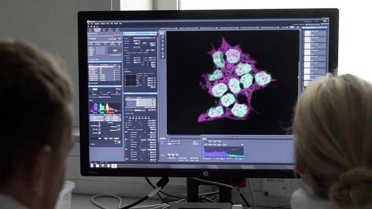 Scientists in front of a computer