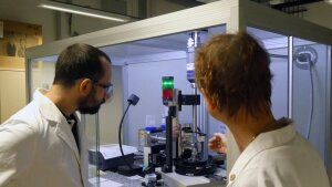 Staff members in front of a powder X-ray diffractometer