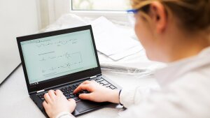 A woman working with a laptop