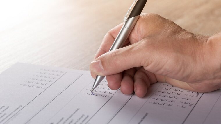 A person fills a survey.